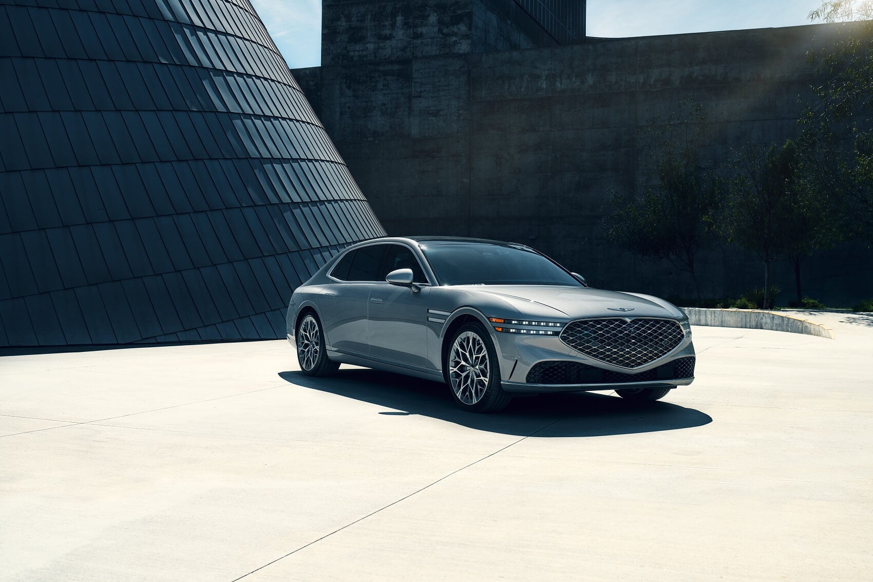 Genesis sedan parked in front of modern building
