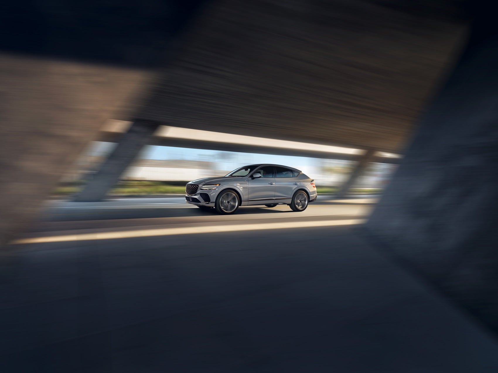 Genesis GV80 driving under city bridge
